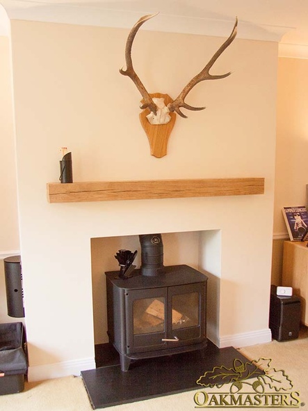 Minimalist fireplace with a straight oak beam