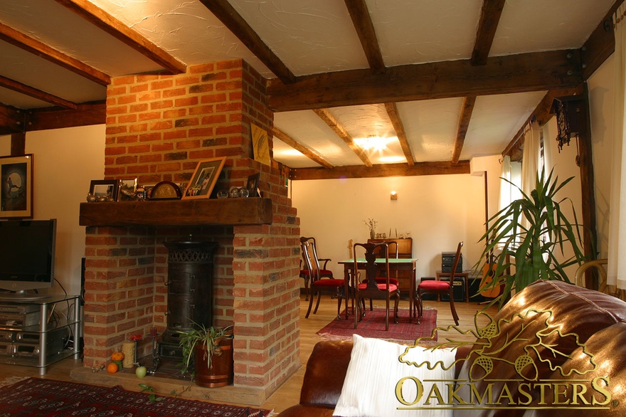 Brick fireplace with an oak beam also serves as room divider