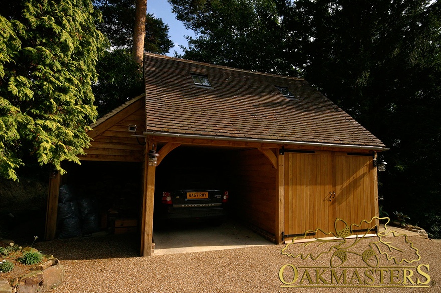 Two bay partially closed oak garage with log store and loft room