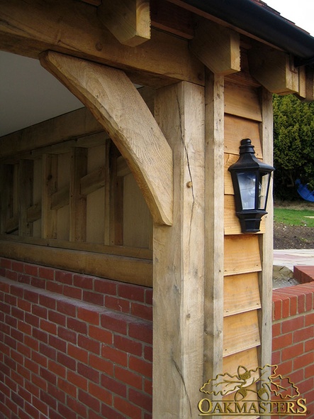 Detail of oak post, bracket and oak featheredge cladding