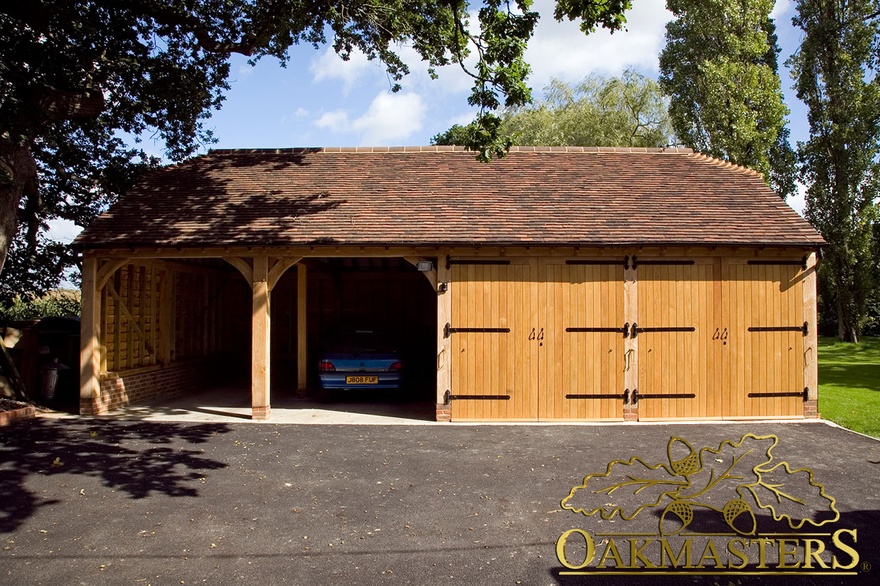Double oak garage doors with three sets of wrought iron hinges