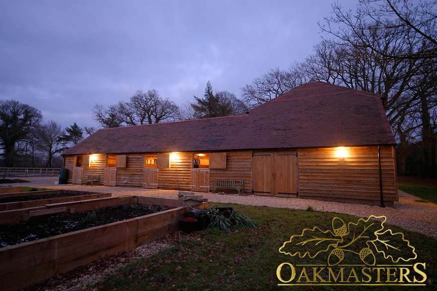 Oak framed stables at night time