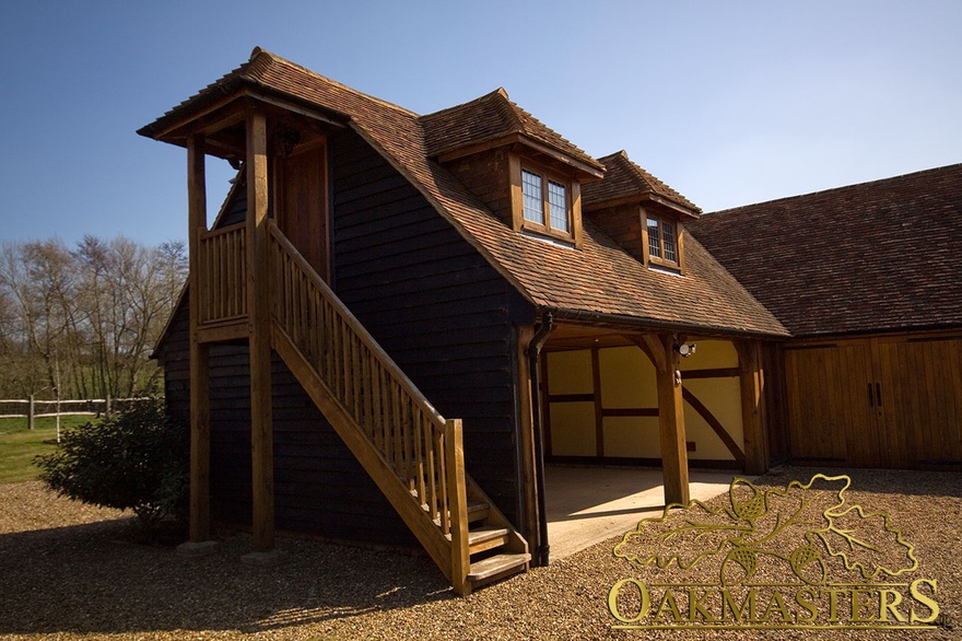 Large L shaped oak framed garage with external staircase
