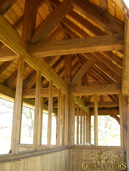 Exposed oak roof, trusses and timber rafters in park rain-shelter