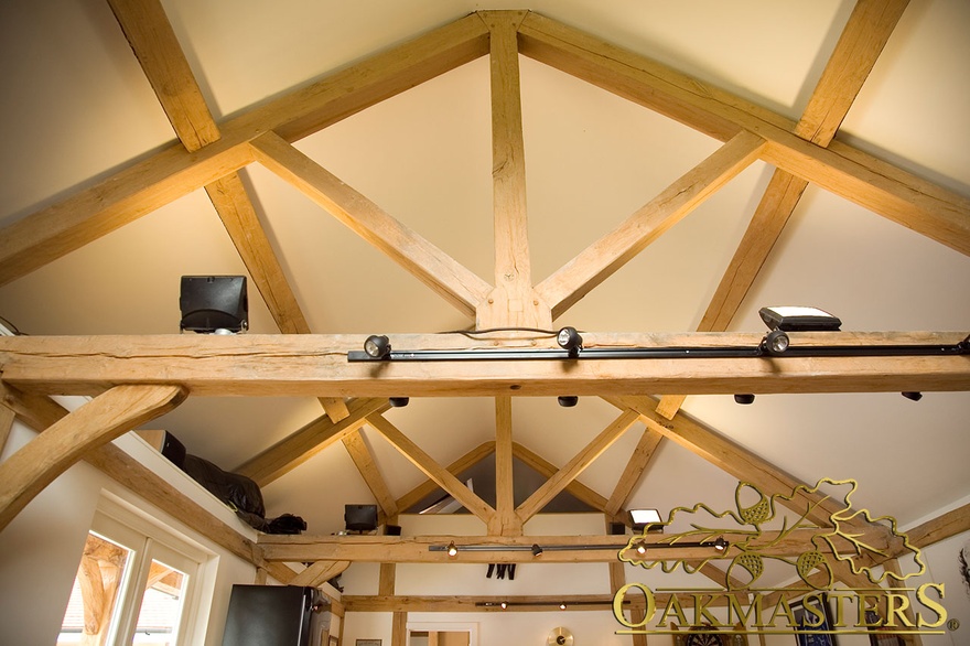Exposed king post trusses inside leisure complex room