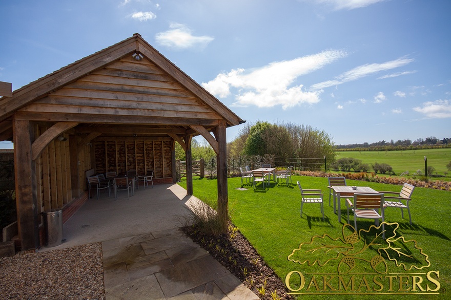 Oak timber clad gable end of undercover seating area and garden shelter