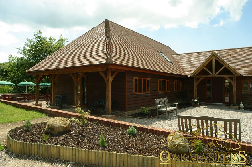 Leisure complex porch with exposed king post truss and curved braces