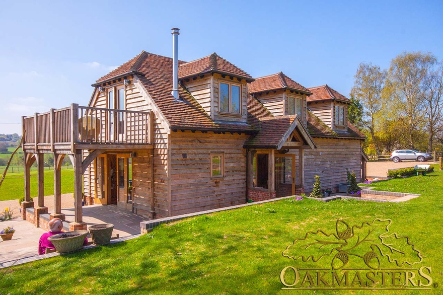 Oak balcony with oak columns and curved braces offers stunning views on fully oak-clad retirement property
