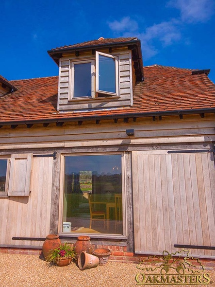 Full height oak-framed glazed window and dormer window in rural retirement home 
