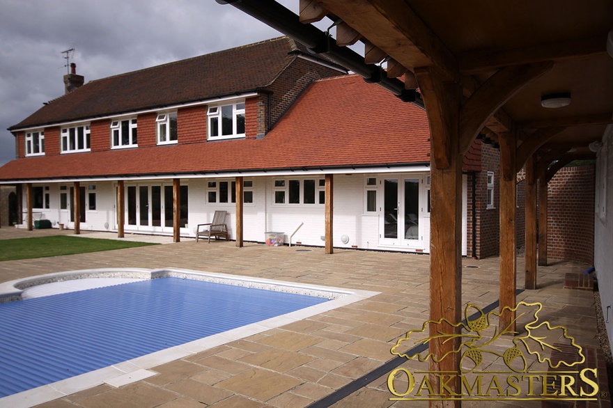 Country house extension with oak columns supporting roof extension