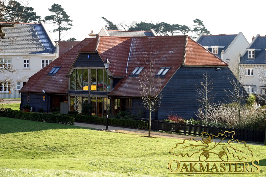 Oak clad and tiled roof marketing suite with large oakframe glazed window elevation