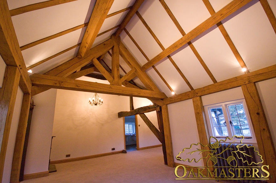 Exposed kingpost truss, rafters and wall frame in listed house hallway