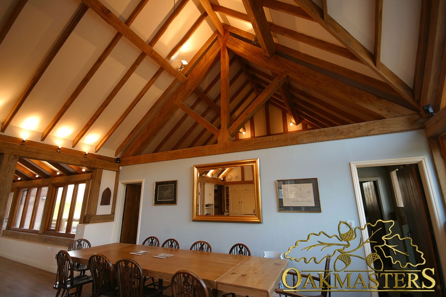 Large exposed king post truss separates dining area from adjoining room