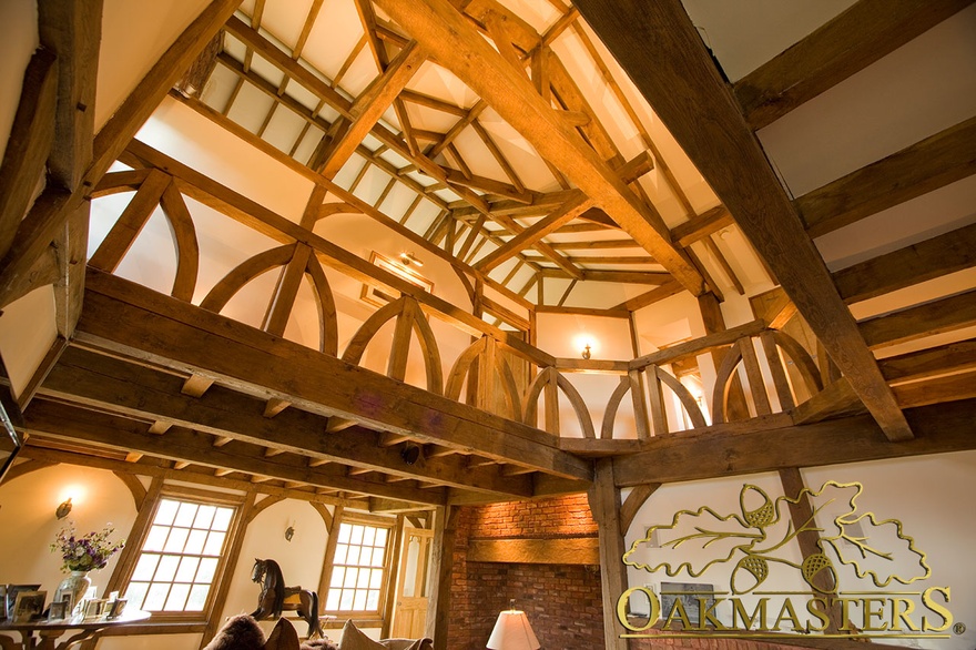 Upstairs gallery hall with curved oak balustrade and exposed ceiling rafters and beams made of manx oak
