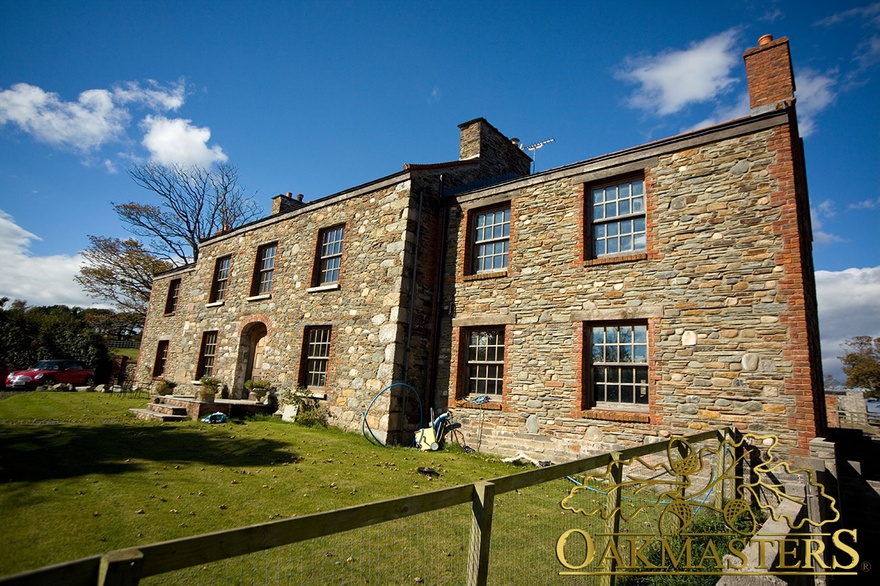 Outside view of manx-oak framed windows, Isle of Man stone house
