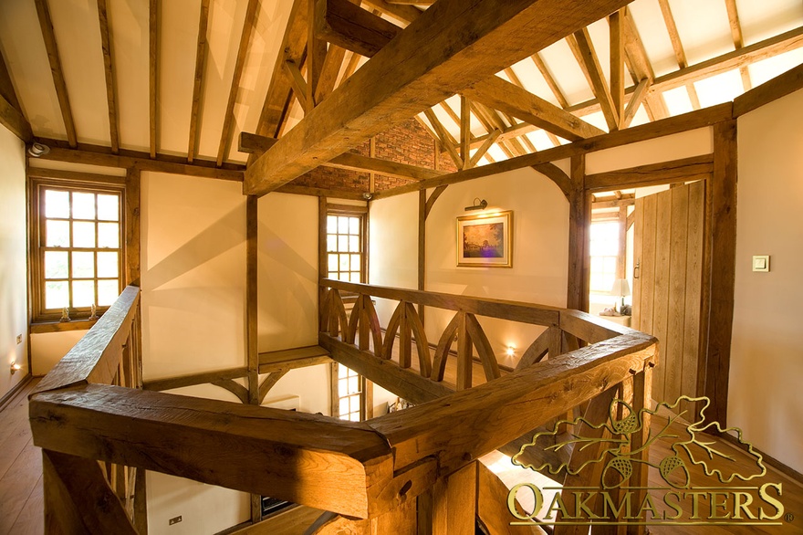 Upstairs gallery hallway with manx oak exposed wood frame and ceiling truss on Isle of Man