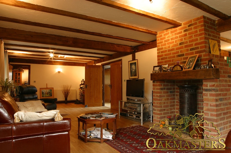 Oak ceiling beams and single beam mantel in sitting room