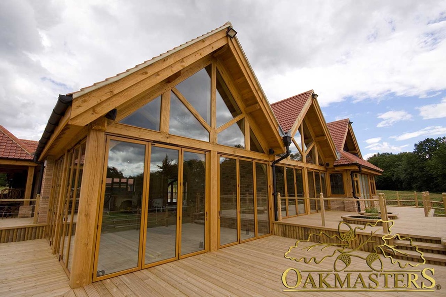Large oak framed glazed gables and patio doors onto oak decking 