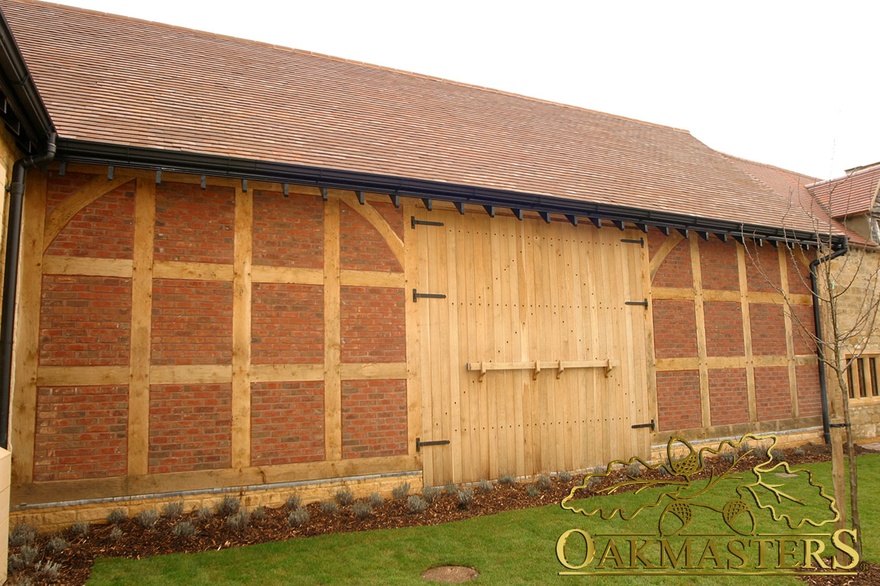 Exposed oak frame and double barn door with traditional door braces and latch on supermarket