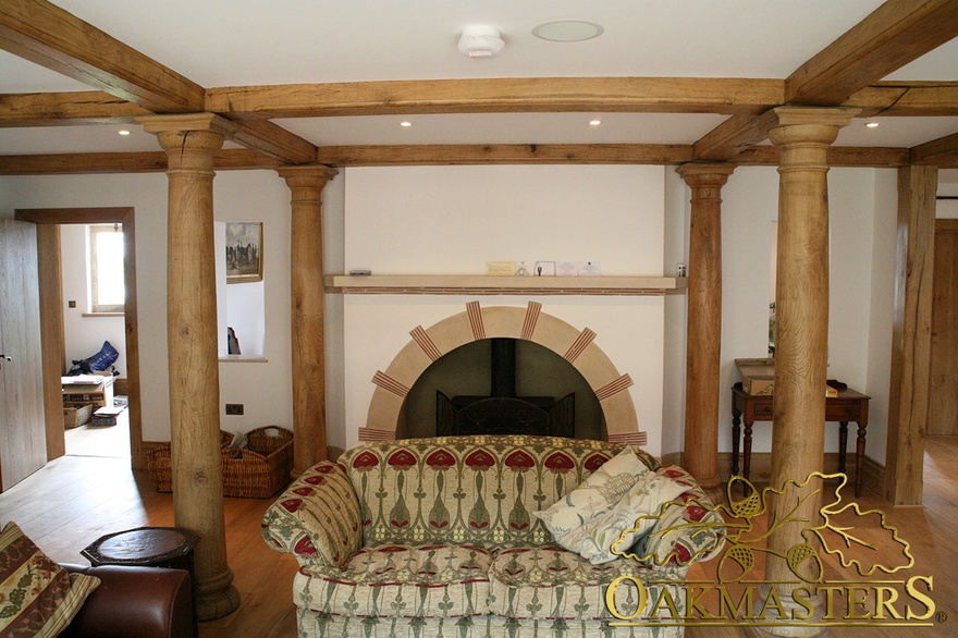 Unique circular oak columns frame sitting room fireplace in unusual country home