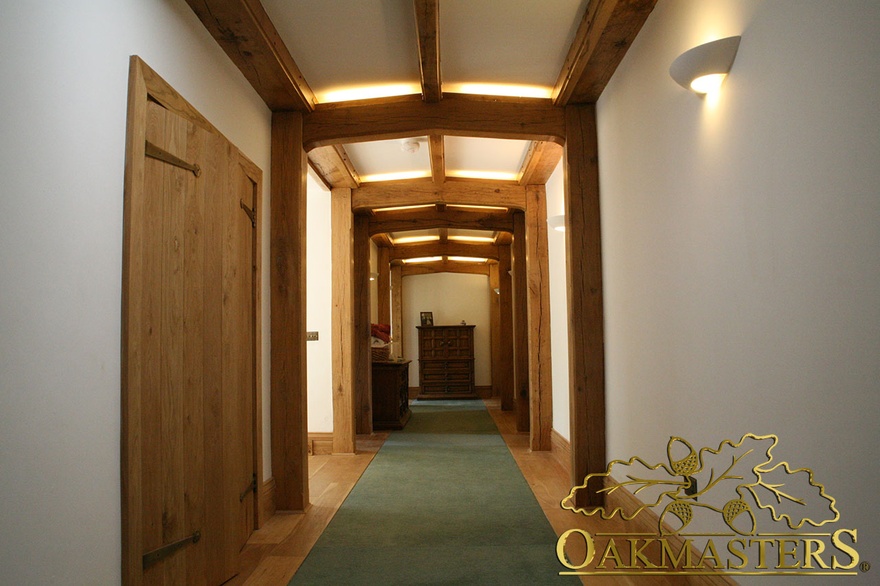 Simple oak beams and columns frame hallway in unusual country house