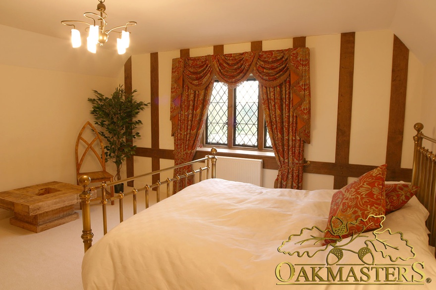 Oak cladding creates a feature wall in this bedroom