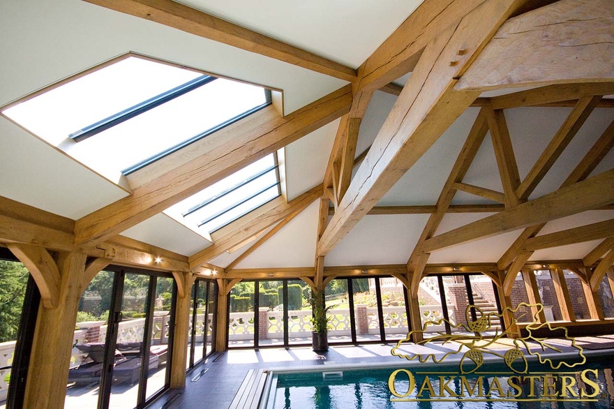 Extensive oak frame full height glazing in pool house with impressive vaulted roof