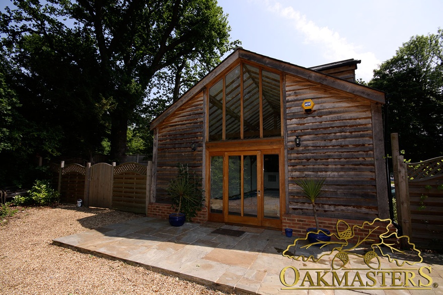 Exterior of vaulted pool house glazed gable and oak cladding