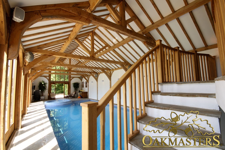 Internal gallery stairs and large exposed oak frame vaulted ceiling in pool house