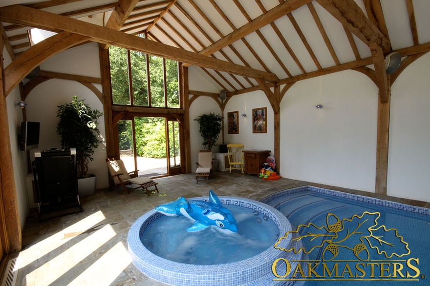 Jacuzzi area in vaulted pool house with large glazed gable