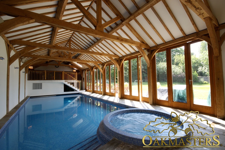 Large poolhouse with exposed oak vaulted ceiling and oak balcony