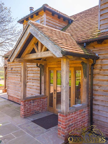 Small oak porch with a king post truss and red tiled roof