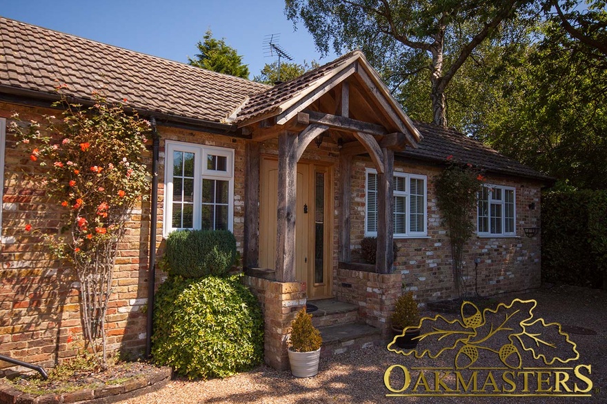 Traditional oak porch on a small brick cottage