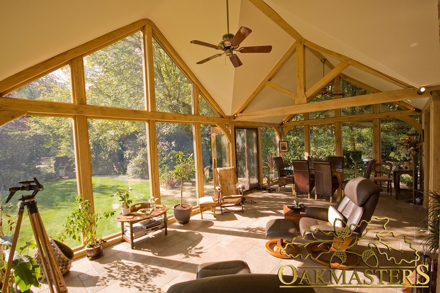 Glazed gables and king post trusses create a wonderful ambiance in this sunroom