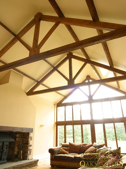 Open vaulted ceiling with exposed king post truss with glazed gable end