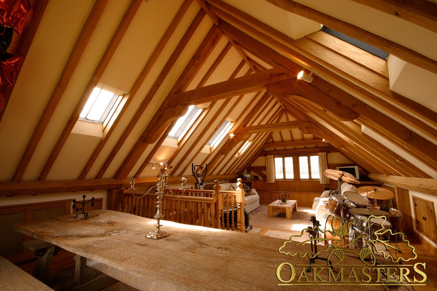 Exposed roof rafters and oak trusses make this garage loft look like a cosy cottage