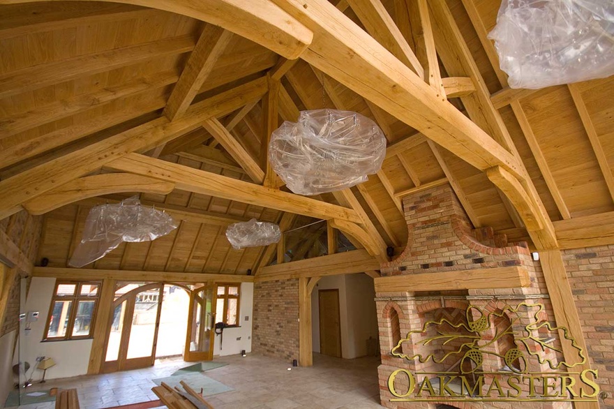 Raised tie trusses above brick fireplace family room
