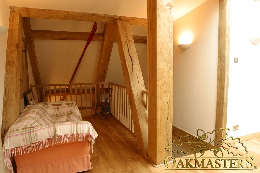 Small attic room with exposed oak beams and oak purlins