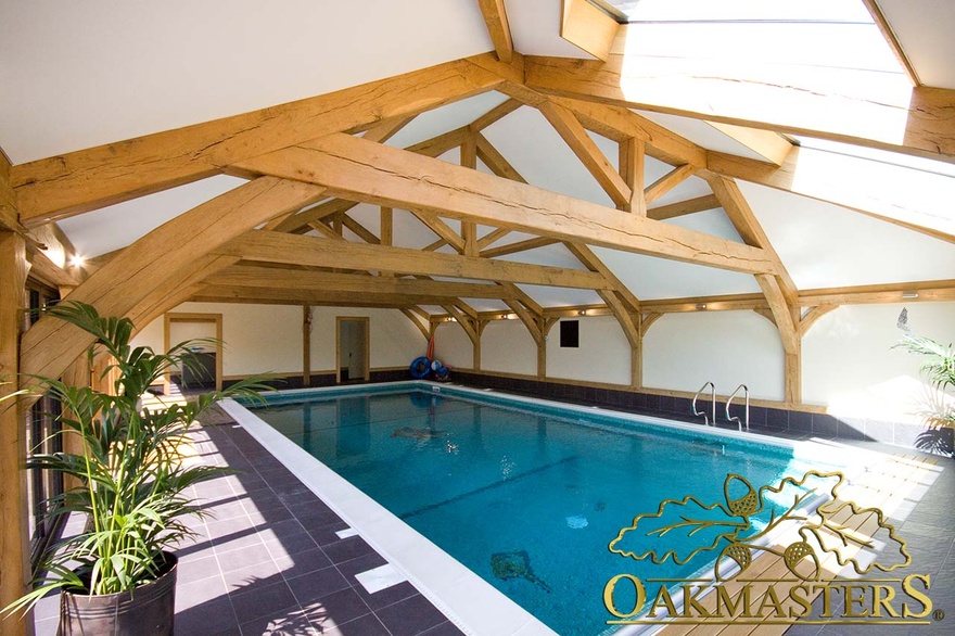 Open raised tie truss raises ceiling height above swimming pool