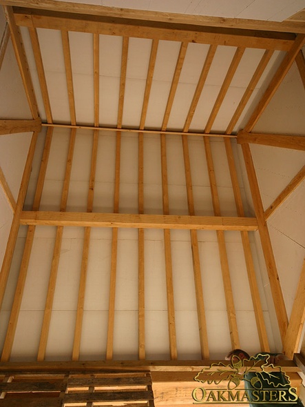 Exposed oak rafters of a high vaulted ceiling