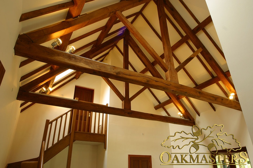 Exposed oak king-post trusses in large open hallway
