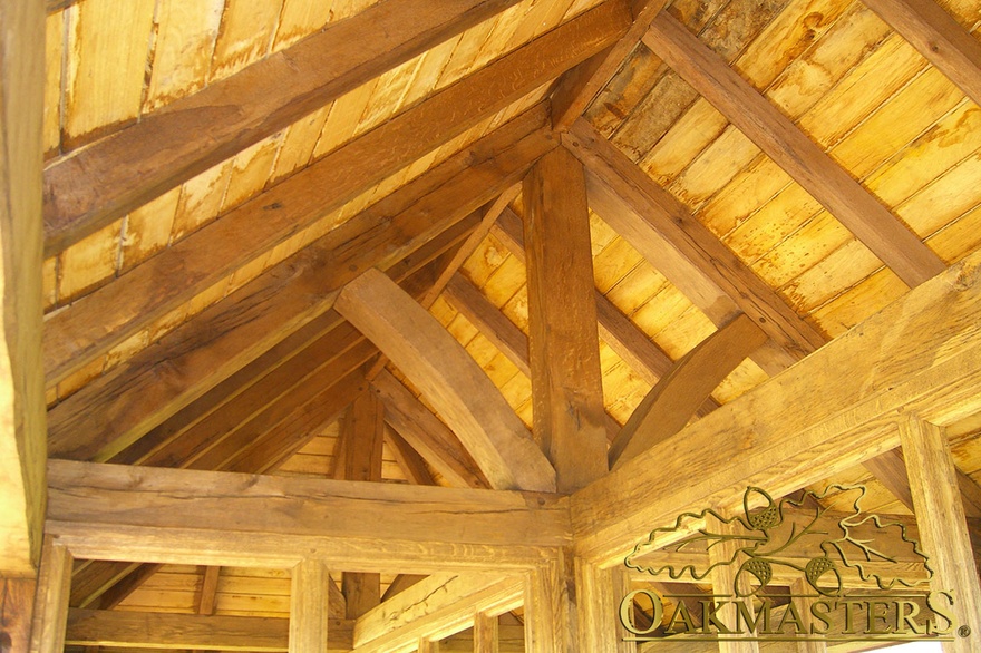 Exposed oak king post truss above partition wall frame