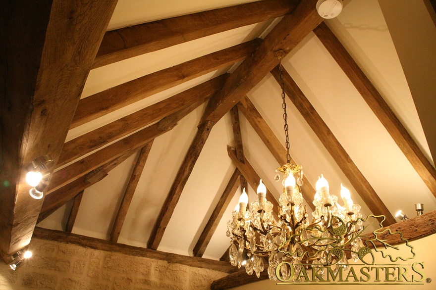 Exposed rafters and chandelier in vaulted ceiling