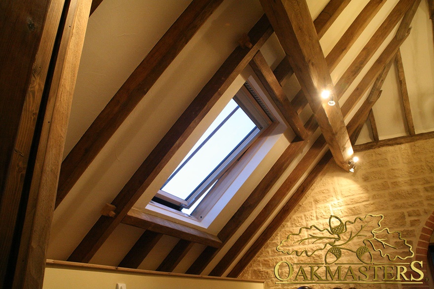 Velux window surrounded by exposed rafters in open ceiling