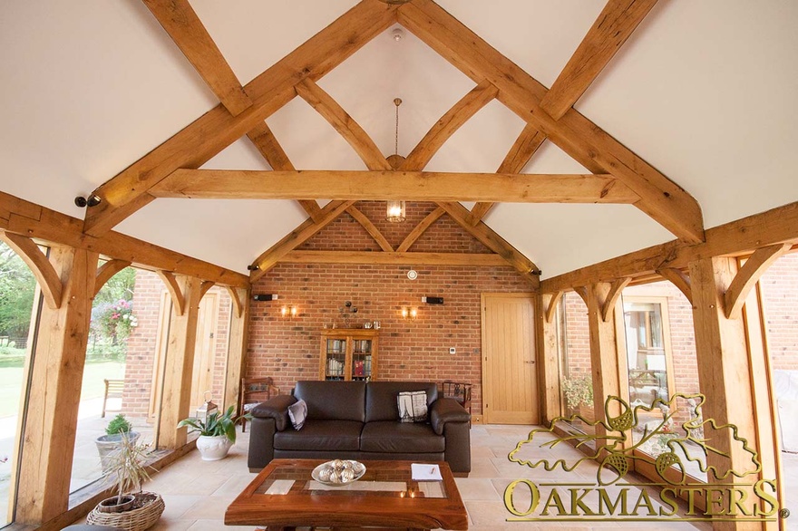 Glazed link room as sitting room with exposed traditional truss