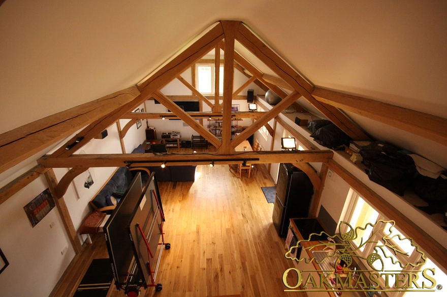 Exposed kingpost trusses create extra height in games room