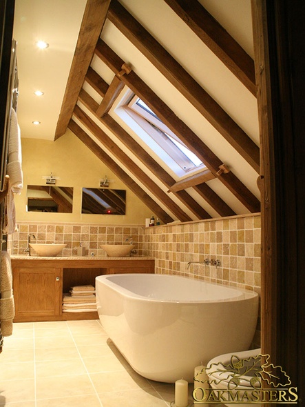 Exposed oak rafters create a point of interest in this bijou but stylish bathroom