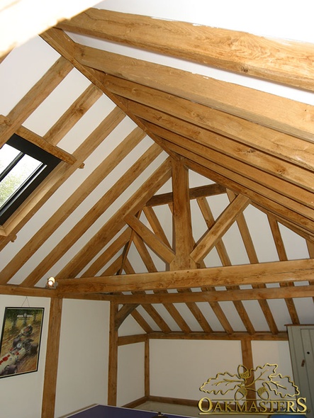 Oak king post truss and exposed roof rafters with oak wall cladding