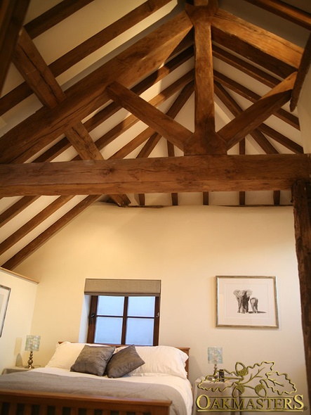 King post truss and exposed rafters in bedroom