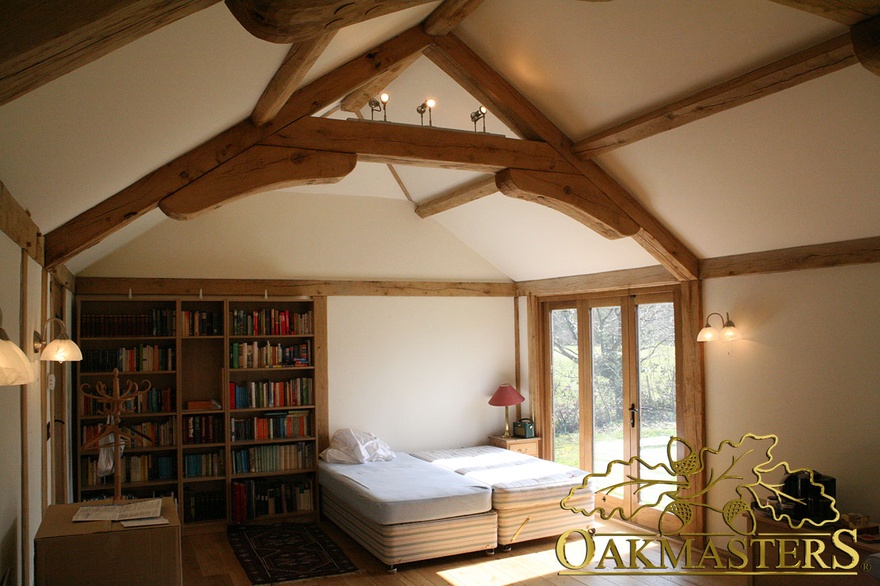 Exposed oak beams, braces and truss and oak frame glazing in cosy garden room